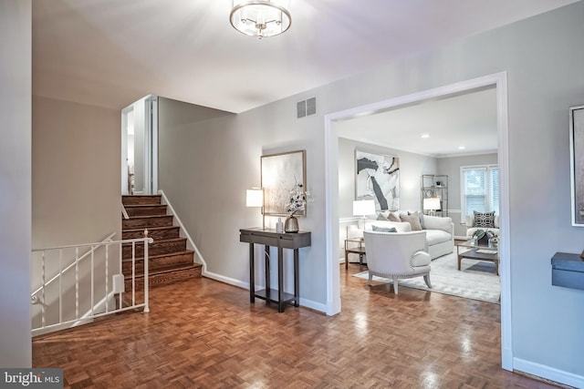 living room featuring a notable chandelier and parquet flooring