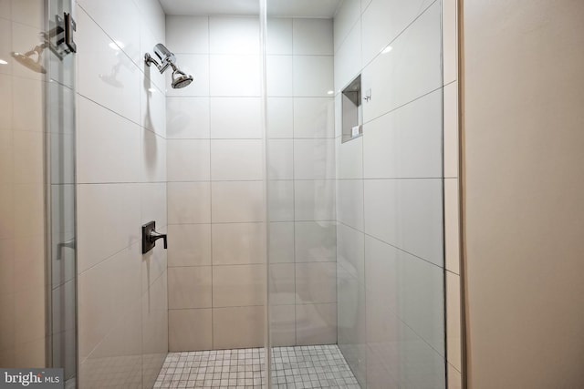 bathroom with a shower with door