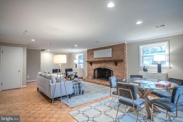 living room with light parquet floors, ornamental molding, and a fireplace