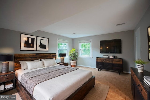 bedroom with light parquet floors