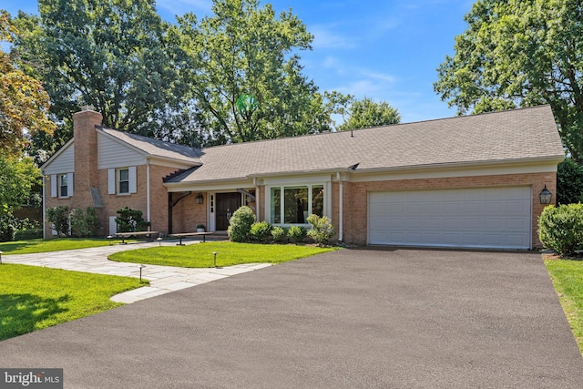 ranch-style home with a garage and a front yard