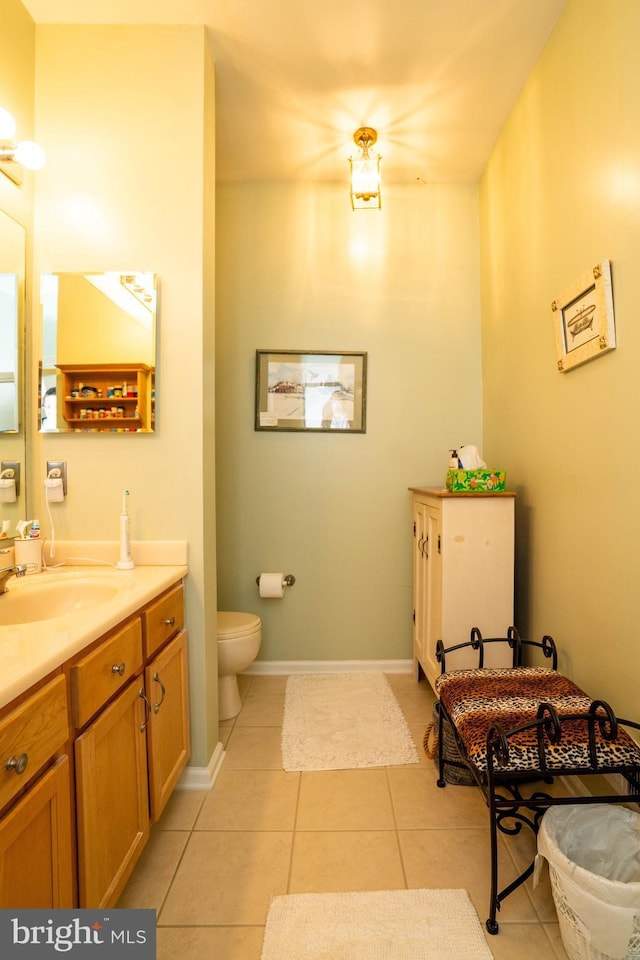 bathroom with vanity, tile patterned floors, and toilet