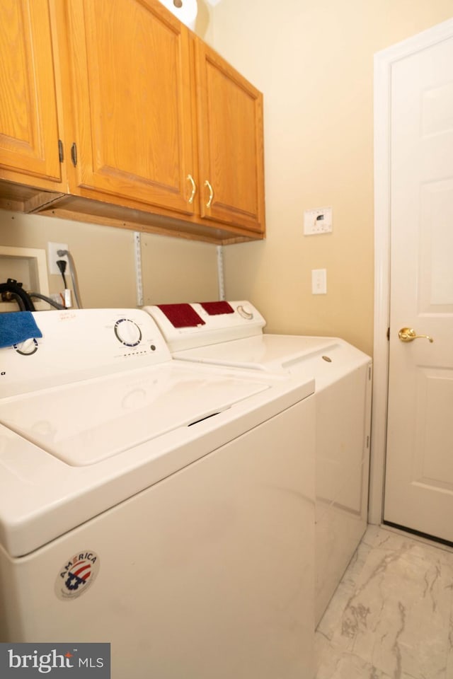 laundry room featuring cabinets and separate washer and dryer