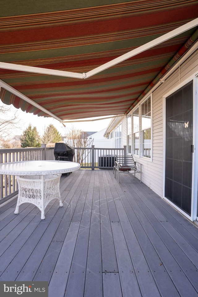 wooden terrace featuring a grill