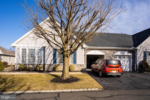 ranch-style home with a garage and a front yard