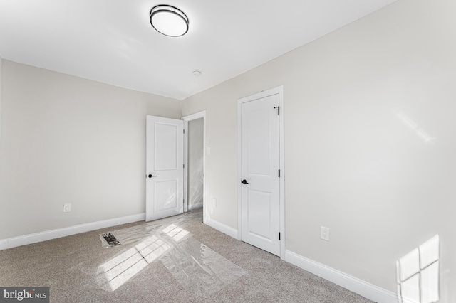 unfurnished bedroom with light colored carpet