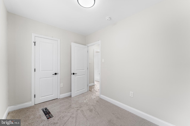 unfurnished bedroom featuring light colored carpet