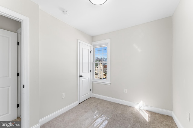 unfurnished room featuring light colored carpet