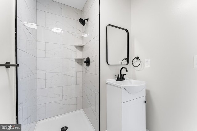 bathroom featuring vanity and tiled shower