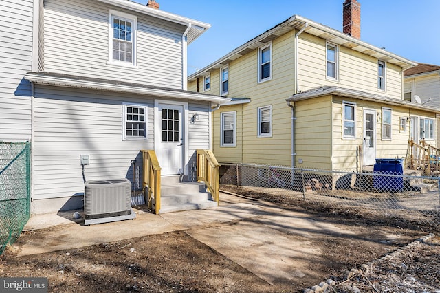 rear view of house with central AC