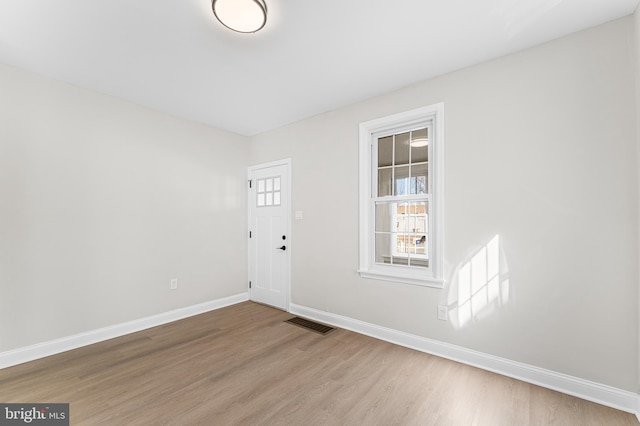 empty room with wood-type flooring