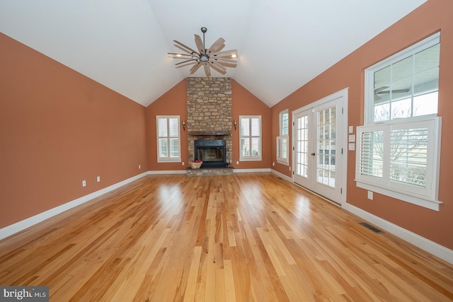 unfurnished living room featuring visible vents, light wood-style flooring, and baseboards