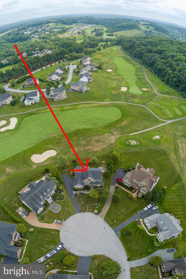 birds eye view of property with view of golf course