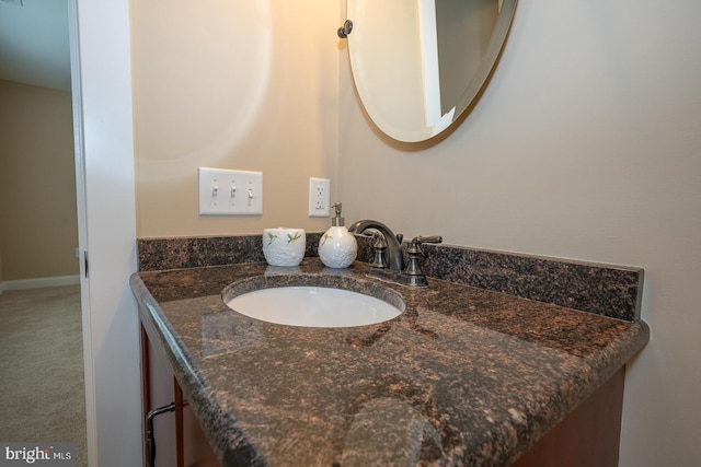 bathroom with baseboards and vanity