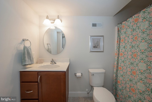 bathroom with tile patterned flooring, toilet, vanity, visible vents, and baseboards