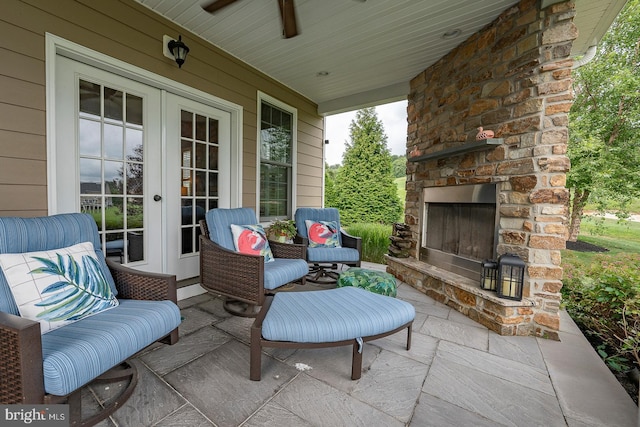 view of patio with an outdoor stone fireplace and french doors