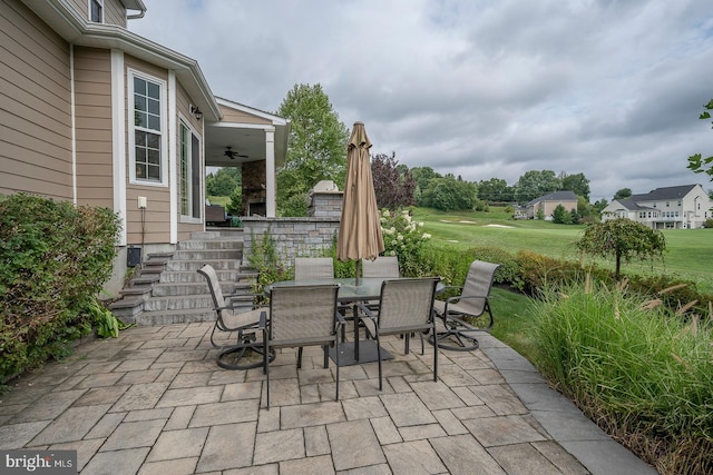 view of patio with outdoor dining space and a ceiling fan