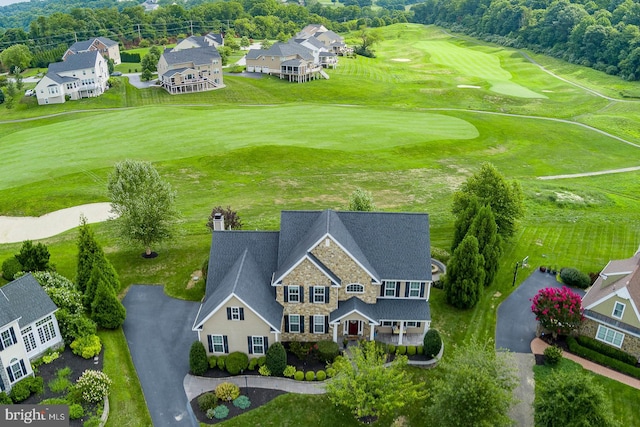 drone / aerial view with golf course view and a residential view