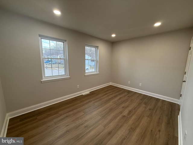 empty room with dark hardwood / wood-style floors