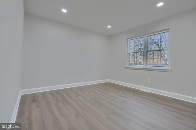 empty room with light hardwood / wood-style flooring