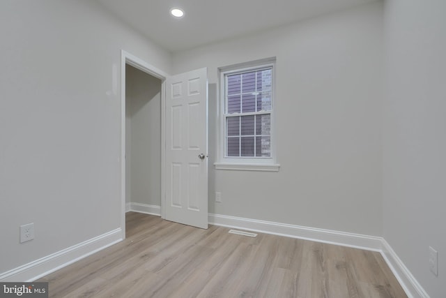 empty room with light hardwood / wood-style floors