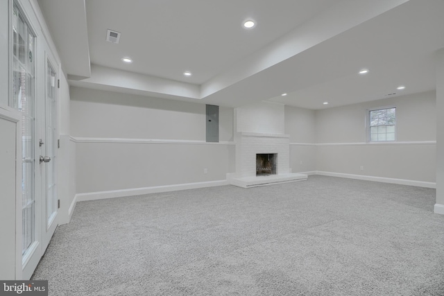 basement featuring a fireplace and carpet