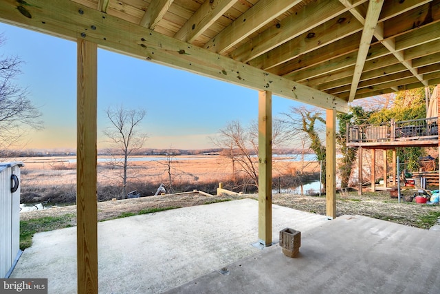 view of patio / terrace featuring a water view and a rural view