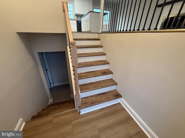 stairs featuring wood-type flooring