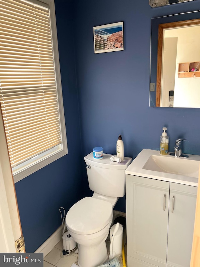 bathroom featuring tile patterned flooring, vanity, and toilet