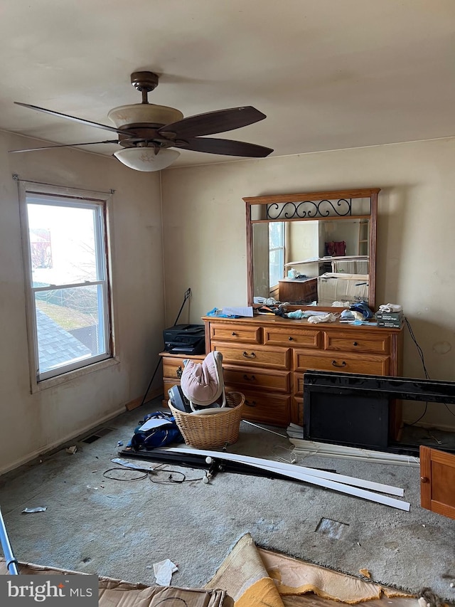 interior space with ceiling fan