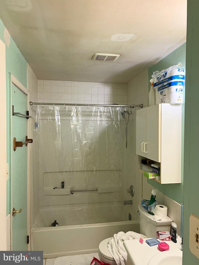 bathroom featuring toilet and shower / bath combo