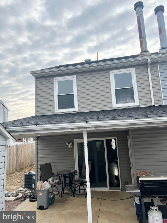 rear view of property featuring central AC and a patio