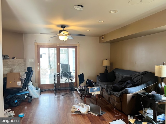 living room featuring ceiling fan and hardwood / wood-style floors