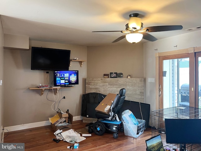 living room with hardwood / wood-style flooring and ceiling fan