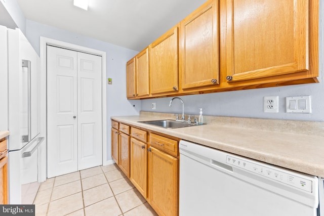 kitchen featuring sink, light tile patterned floors, and white appliances