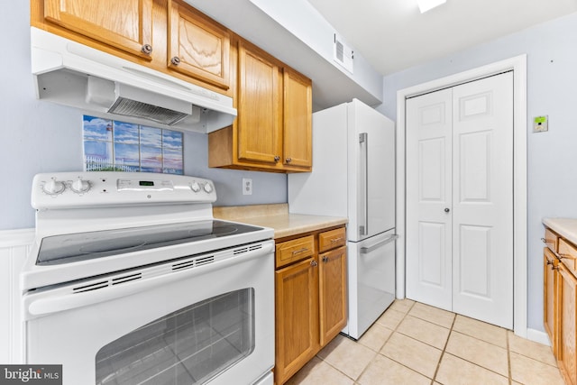 kitchen featuring extractor fan, white appliances, and light tile patterned flooring