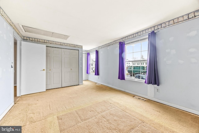 unfurnished bedroom featuring carpet flooring and a closet