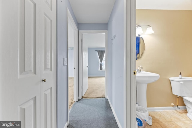 corridor with light colored carpet