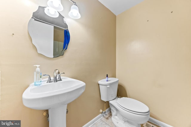 bathroom featuring sink and toilet