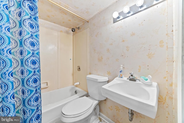 full bathroom with shower / tub combo with curtain, sink, and toilet