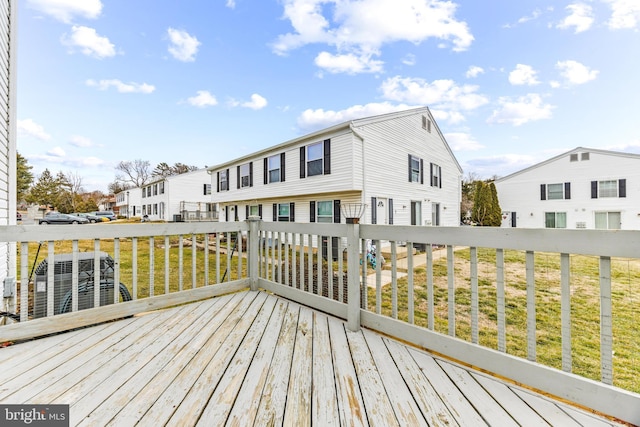 wooden deck with a yard and central AC