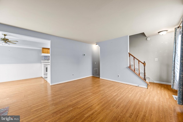 unfurnished living room with ceiling fan and light hardwood / wood-style floors