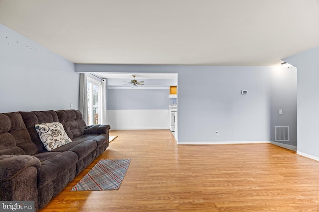 living room with ceiling fan and light hardwood / wood-style floors