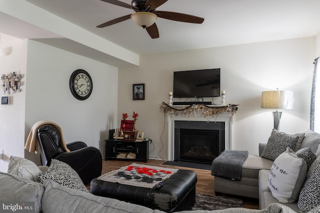 living room featuring ceiling fan, a fireplace, and hardwood / wood-style floors