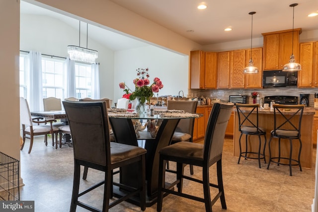 dining space featuring lofted ceiling and an inviting chandelier