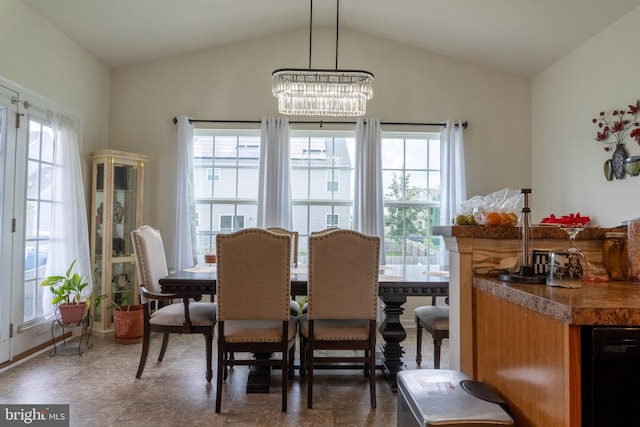 dining space featuring vaulted ceiling and a chandelier