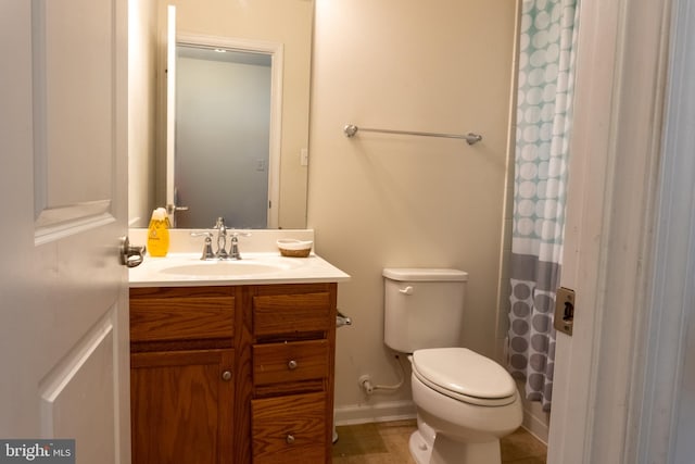 bathroom featuring vanity, a shower with curtain, and toilet