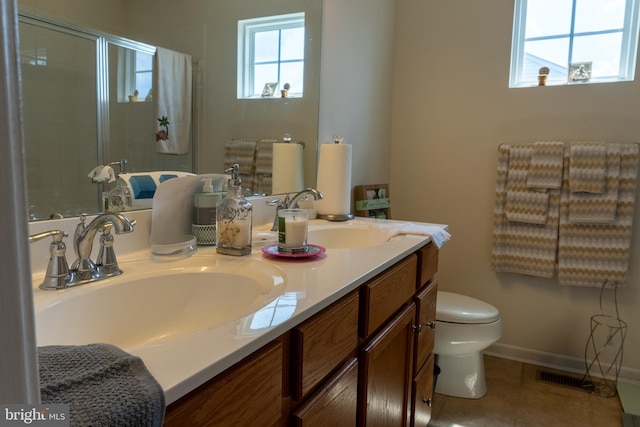 bathroom featuring vanity, tile patterned floors, toilet, and walk in shower