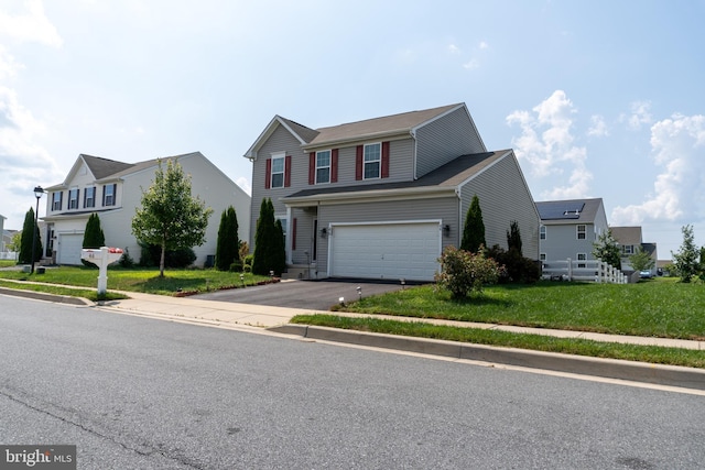 view of front facade with a garage and a front yard