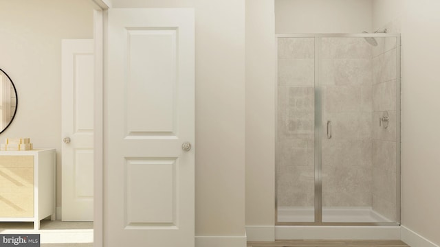 bathroom featuring vanity and an enclosed shower